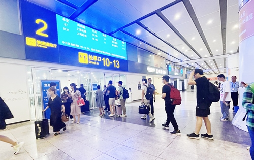 在快速進(jìn)站廳前排隊(duì)等待檢票的旅客。人民網(wǎng)記者 喬雪峰攝