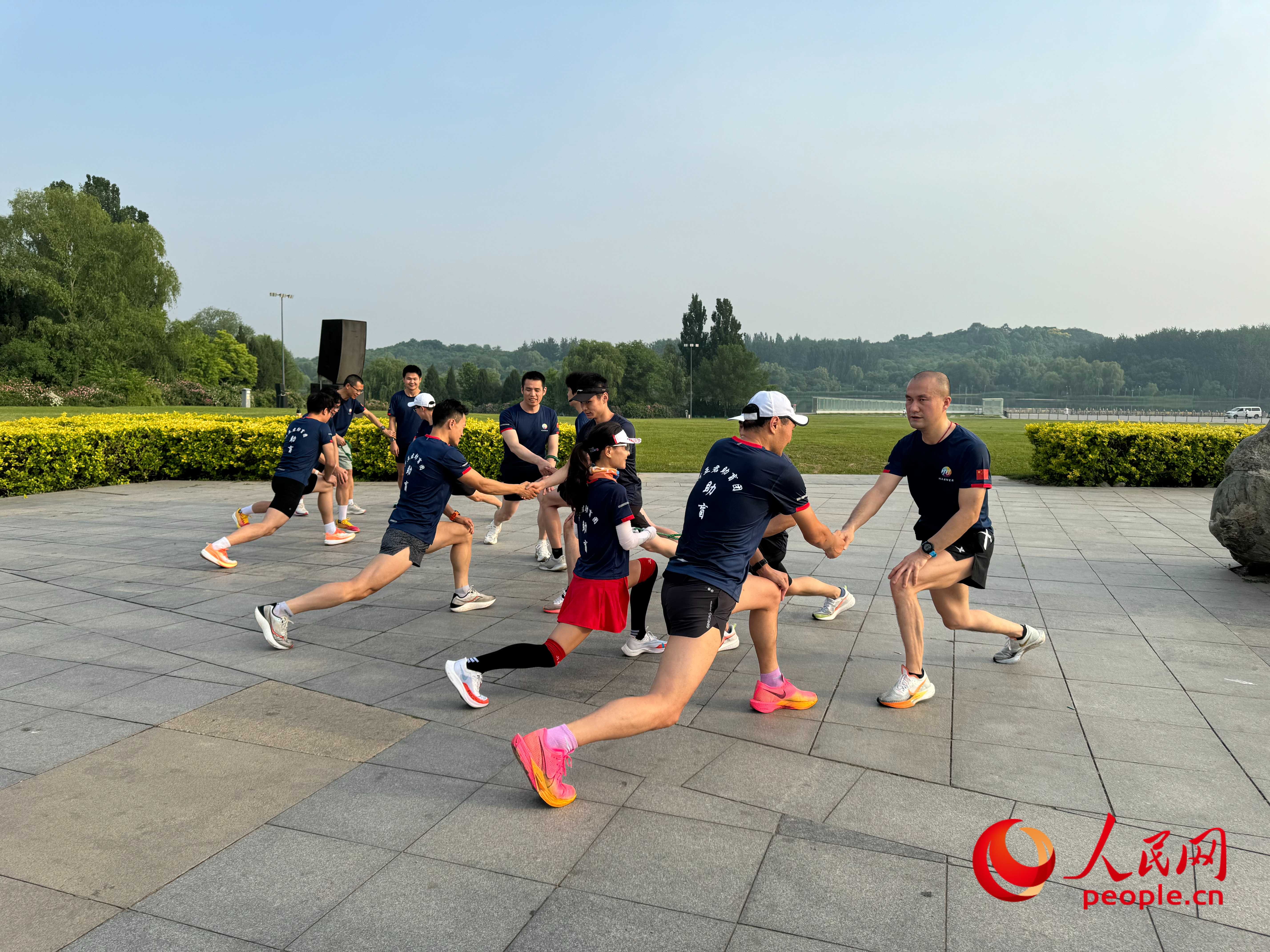 盲人和志愿者做跑步前準(zhǔn)備。人民網(wǎng) 周靜圓攝